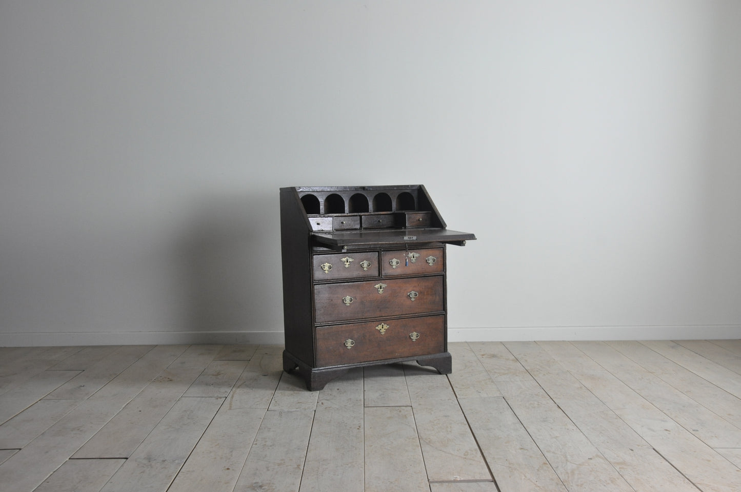 Early oak bureau with well and secret drawer
