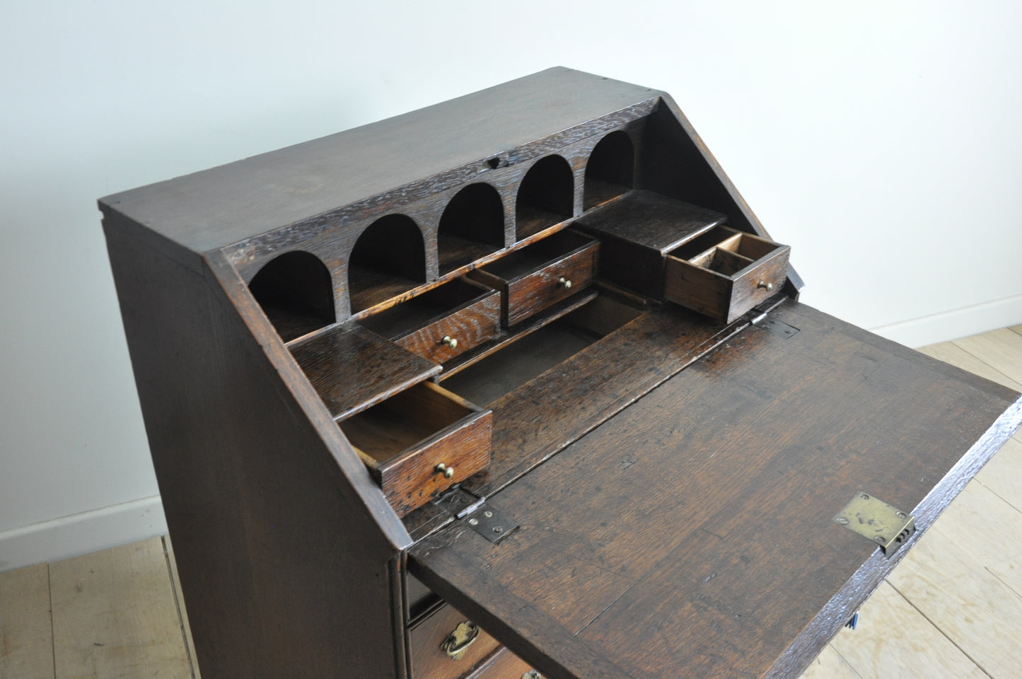 Early oak bureau with well and secret drawer