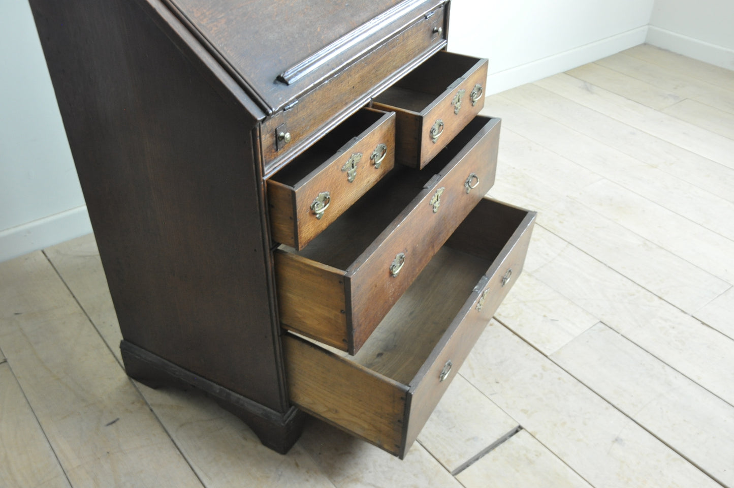 Early oak bureau with well and secret drawer