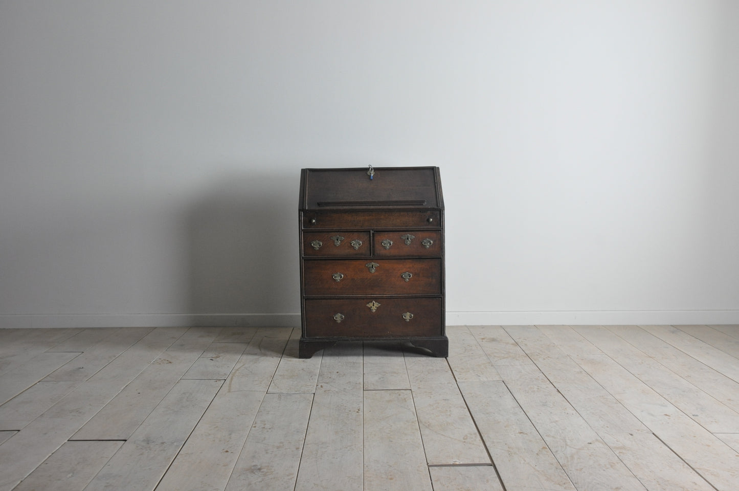 Early oak bureau with well and secret drawer