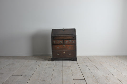 Early oak bureau with well and secret drawer