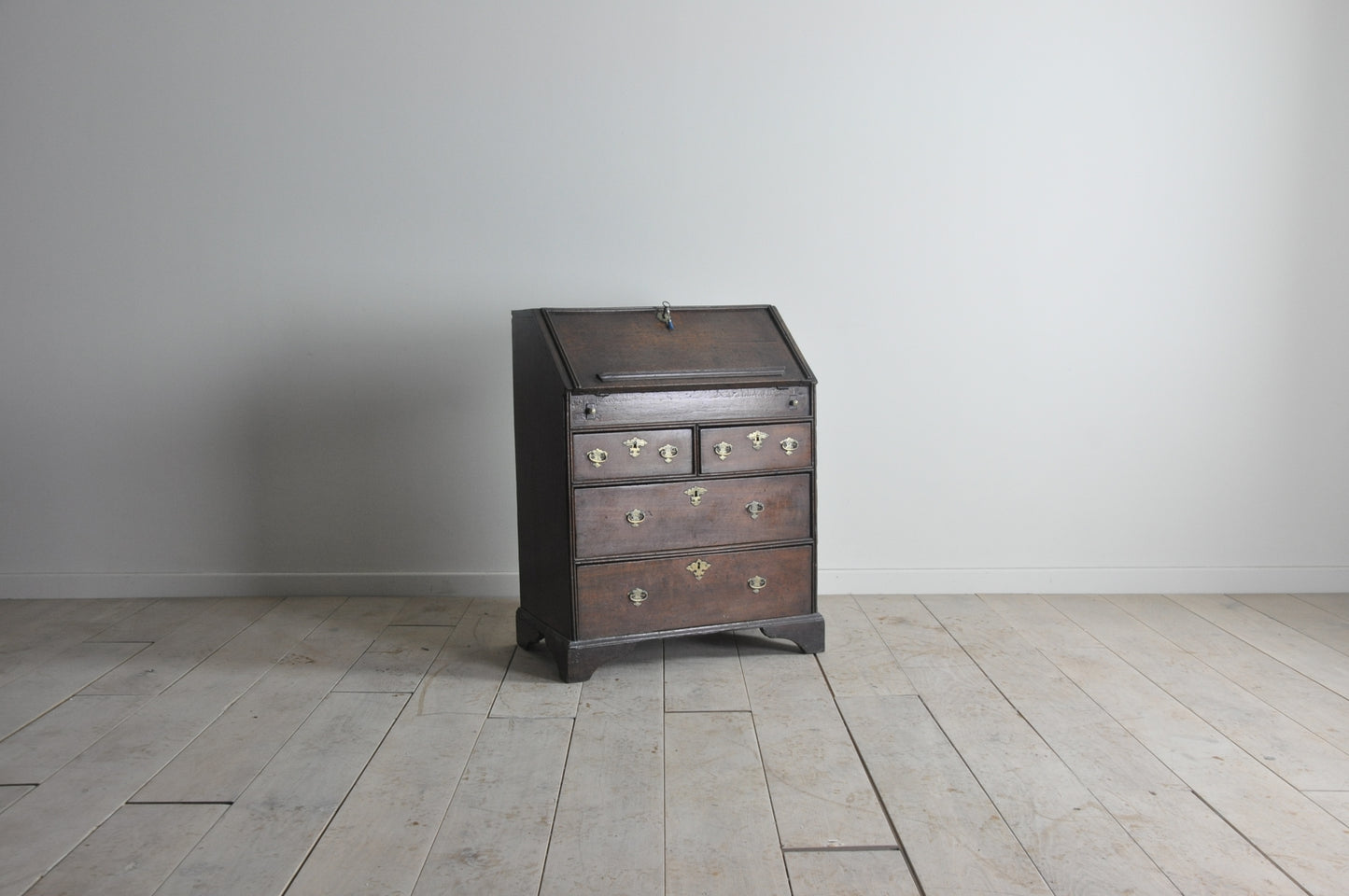 Early oak bureau with well and secret drawer